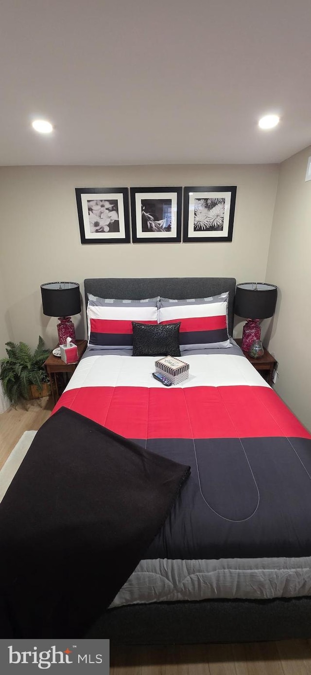 bedroom with wood finished floors and recessed lighting