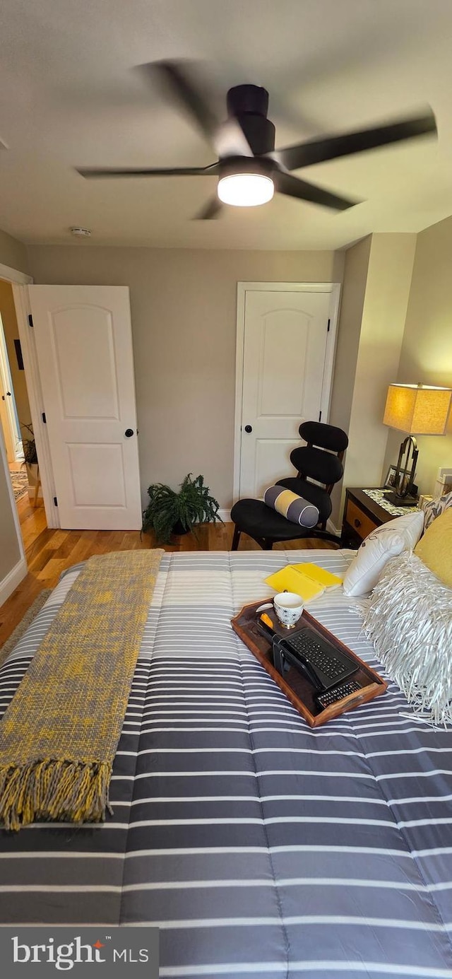 bedroom featuring ceiling fan and wood finished floors