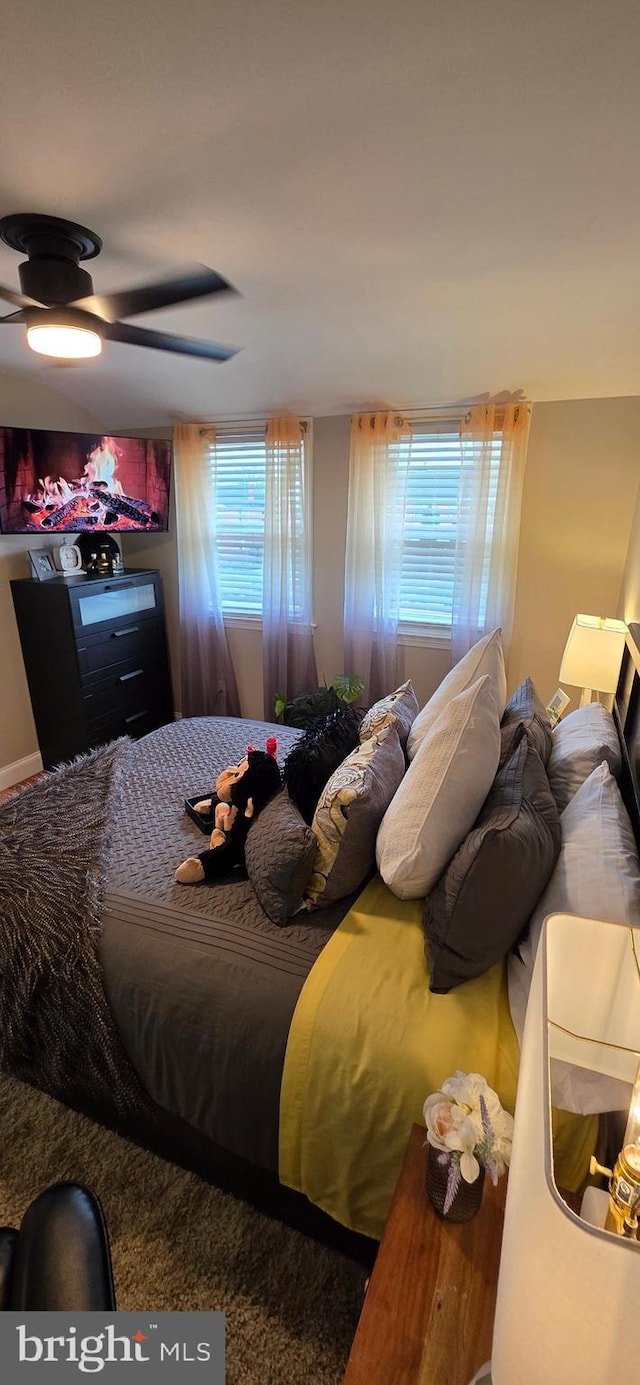 bedroom with multiple windows and a ceiling fan