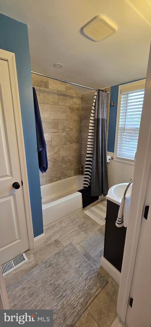 full bathroom with shower / bathtub combination with curtain and vanity