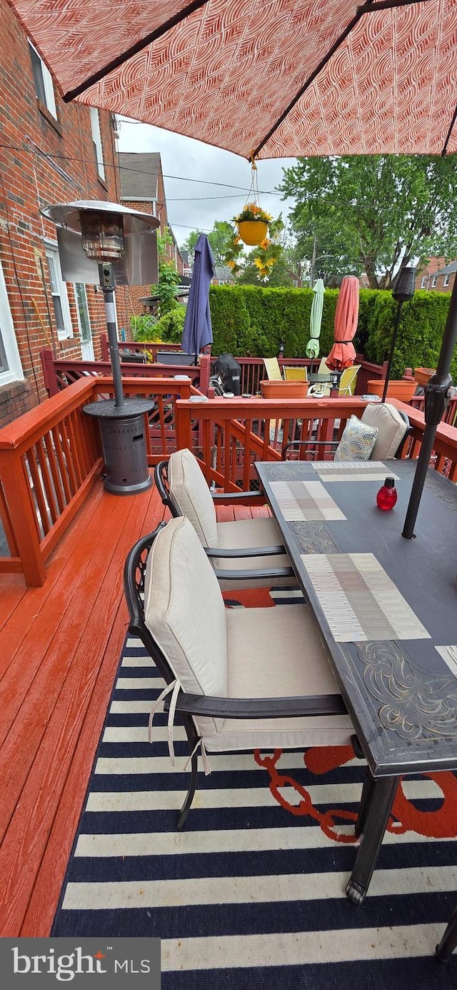 wooden terrace featuring outdoor dining area