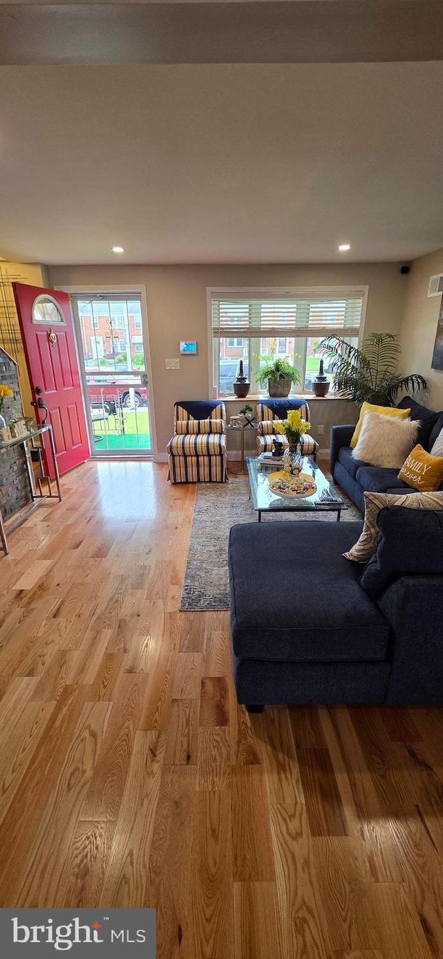 living area with wood finished floors and recessed lighting