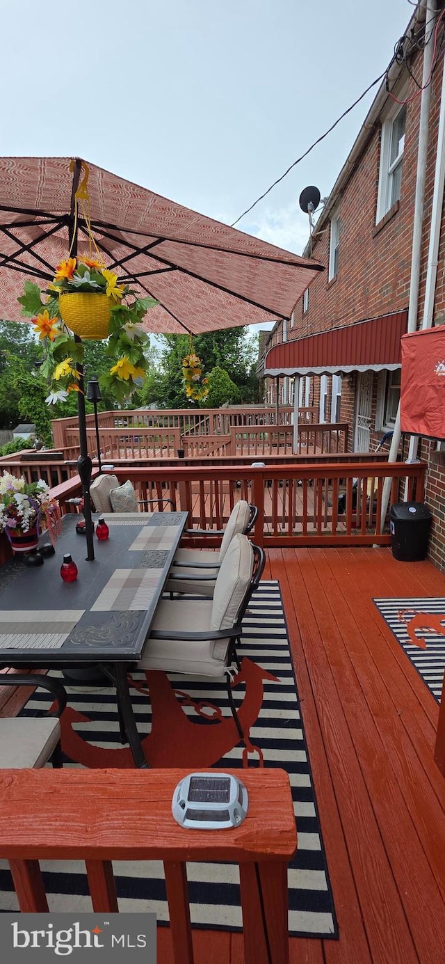 wooden terrace with outdoor dining area