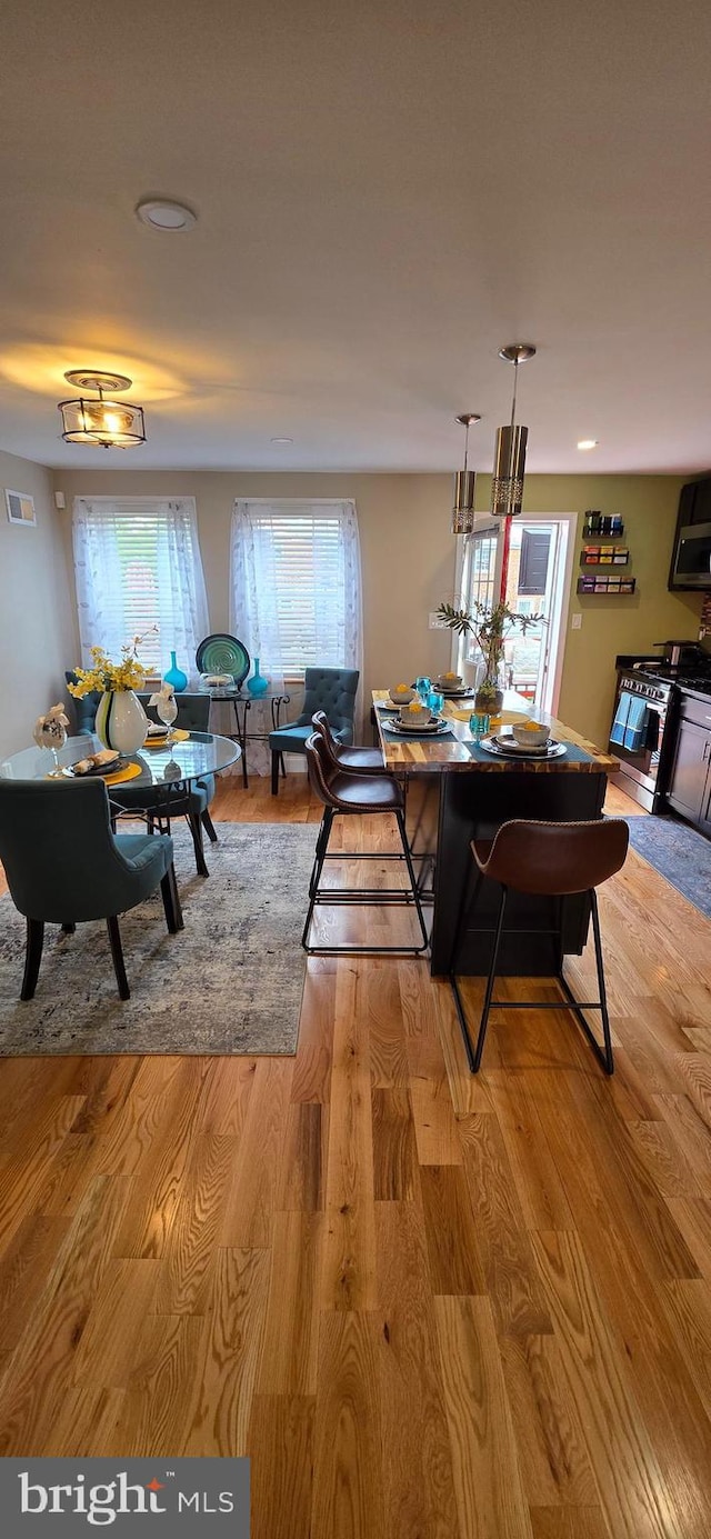 dining room featuring light wood-style flooring and recessed lighting