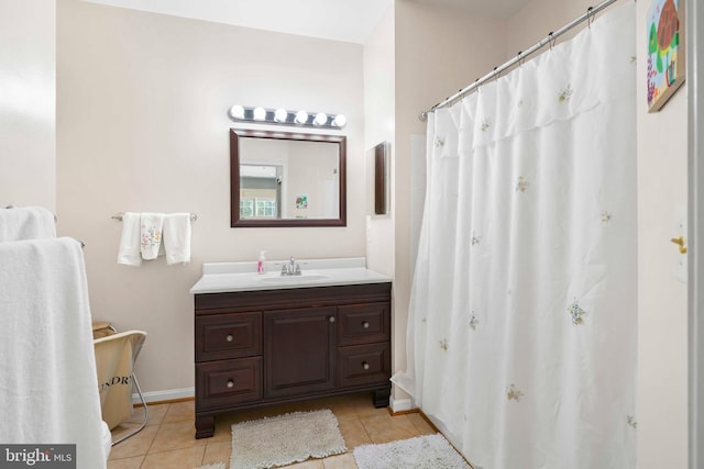 bathroom featuring tile patterned flooring, baseboards, and vanity