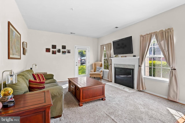 living room with light colored carpet, plenty of natural light, and baseboards