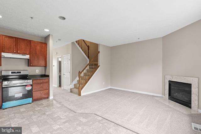 9711 Luguna Rd, Baltimore, MD 21220 - kitchen featuring stainless steel range with electric stovetop, under cabinet range hood, brown cabinetry, baseboards, and recessed lighting