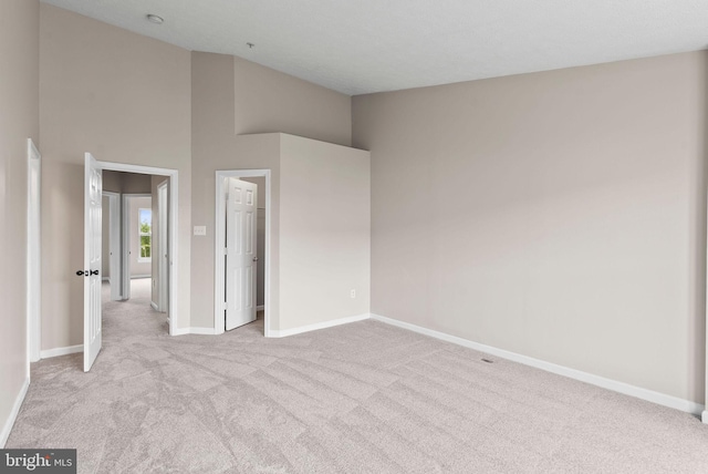 9711 Luguna Rd, Baltimore, MD 21220 - unfurnished bedroom with light carpet, baseboards, and a towering ceiling