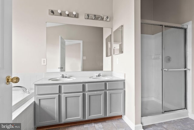 9711 Luguna Rd, Baltimore, MD 21220 - bathroom with a shower stall, a garden tub, double vanity, and baseboards