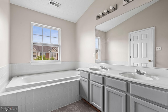 9711 Luguna Rd, Baltimore, MD 21220 - full bathroom featuring a bath, double vanity, and a textured ceiling