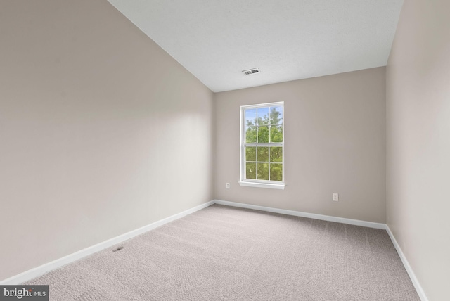 9711 Luguna Rd, Baltimore, MD 21220 - spare room with light carpet, baseboards, and vaulted ceiling