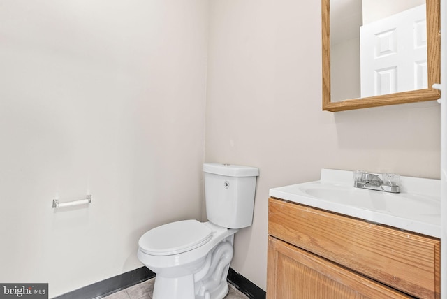 9711 Luguna Rd, Baltimore, MD 21220 - bathroom with baseboards, toilet, vanity, and tile patterned floors