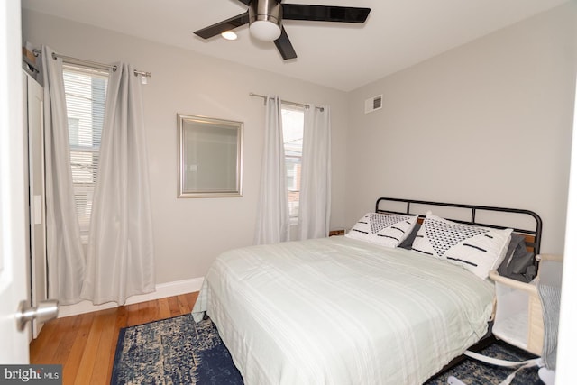 bedroom with wood finished floors, ceiling fan, and baseboards