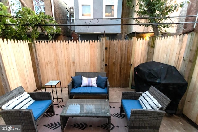 view of patio featuring fence, outdoor lounge area, and grilling area