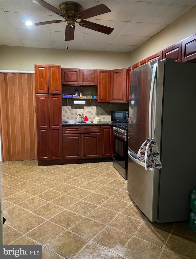 813 E Russell St, Philadelphia, PA 19134 - kitchen with appliances with stainless steel finishes, dark countertops, a ceiling fan, decorative backsplash, and open shelves