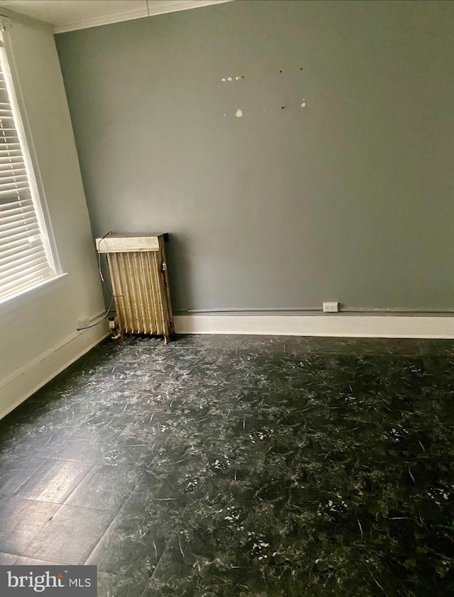 813 E Russell St, Philadelphia, PA 19134 - spare room featuring baseboards and radiator
