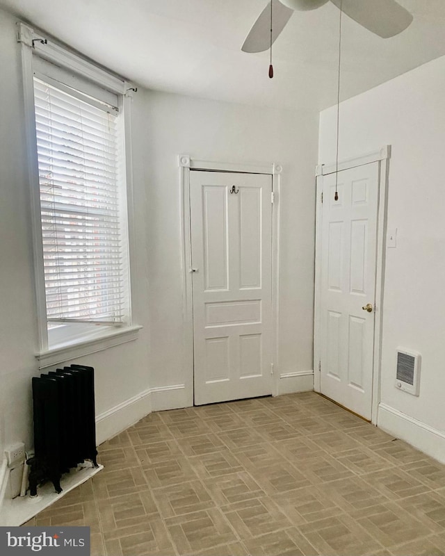 813 E Russell St, Philadelphia, PA 19134 - unfurnished bedroom featuring baseboards, a ceiling fan, and radiator