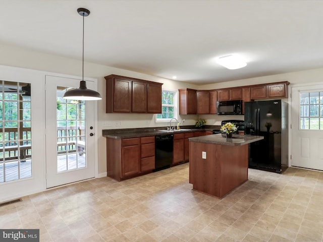 375 Arrowhead Rd, Front Royal, VA 22630 - kitchen featuring black appliances, a sink, dark countertops, and a center island