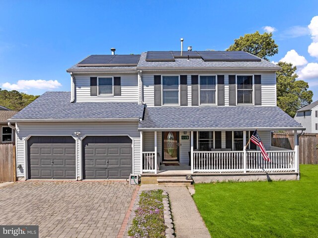 115 Holly Ct, Tuckerton, NJ 08087 - view of front facade with covered porch, driveway, roof mounted solar panels, and a shingled roof