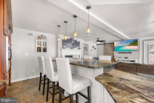 115 Holly Ct, Tuckerton, NJ 08087 - kitchen with open floor plan, a breakfast bar area, baseboards, and dark stone finish floors