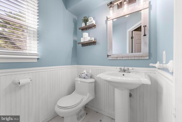 115 Holly Ct, Tuckerton, NJ 08087 - bathroom featuring toilet, wainscoting, tile patterned flooring, and a sink
