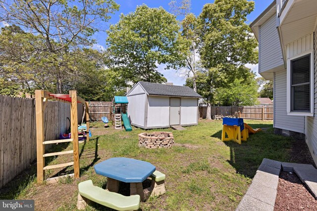 115 Holly Ct, Tuckerton, NJ 08087 - view of yard with a playground, a storage unit, a fire pit, and an outdoor structure