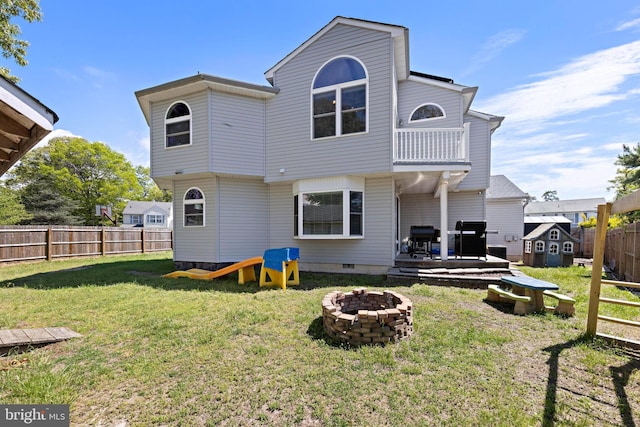 115 Holly Ct, Tuckerton, NJ 08087 - back of property with a fire pit, a shed, an outdoor structure, a balcony, and a wooden deck