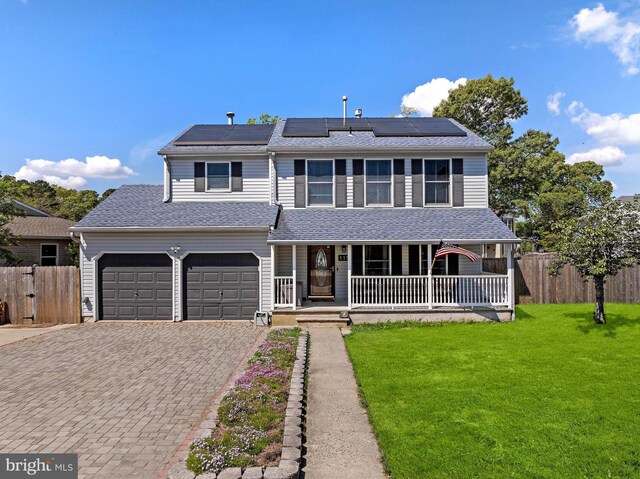 115 Holly Ct, Tuckerton, NJ 08087 - view of front facade with covered porch, decorative driveway, roof mounted solar panels, and roof with shingles