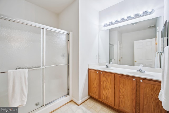 2604 Chapel Lake Dr Unit 107, Gambrills, MD 21054 - full bathroom with a shower stall, double vanity, tile patterned flooring, and baseboards