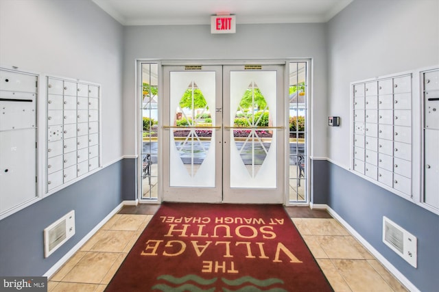 2604 Chapel Lake Dr Unit 107, Gambrills, MD 21054 - doorway with mail area, tile patterned flooring, crown molding, and baseboards