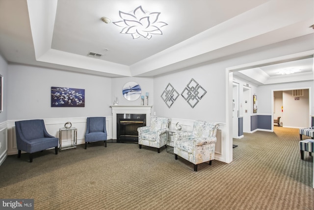 2604 Chapel Lake Dr Unit 107, Gambrills, MD 21054 - sitting room featuring a raised ceiling, carpet floors, a glass covered fireplace, and baseboards