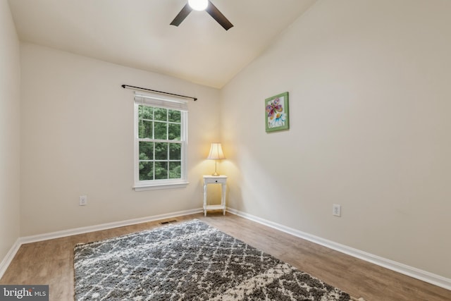 7879 Wintercress Ln, Springfield, VA 22152 - spare room with a ceiling fan, wood finished floors, vaulted ceiling, and baseboards