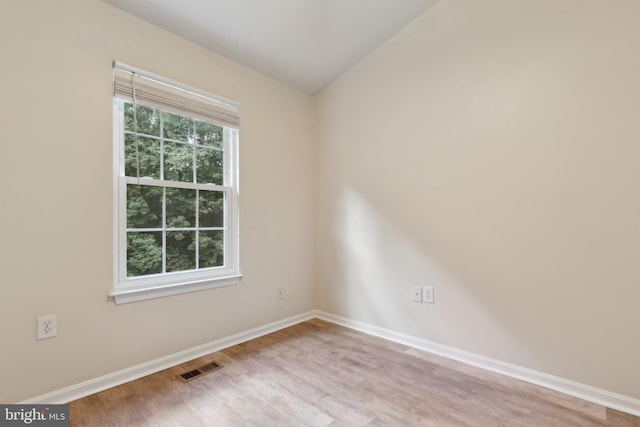 7879 Wintercress Ln, Springfield, VA 22152 - spare room with wood finished floors, baseboards, and vaulted ceiling