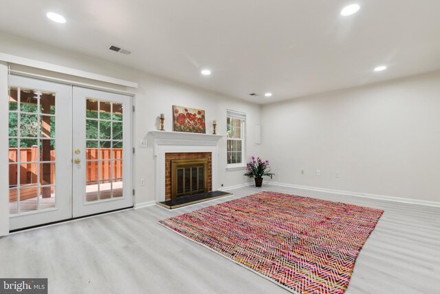 7879 Wintercress Ln, Springfield, VA 22152 - living room featuring wood finished floors, french doors, recessed lighting, baseboards, and a brick fireplace