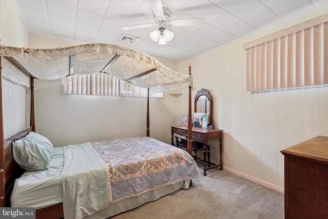 carpeted bedroom with ceiling fan, ornamental molding, and baseboards