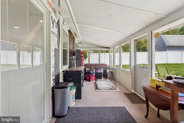 sunroom featuring vaulted ceiling