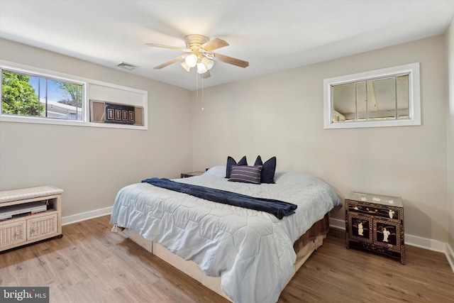 bedroom with baseboards, wood finished floors, and ceiling fan