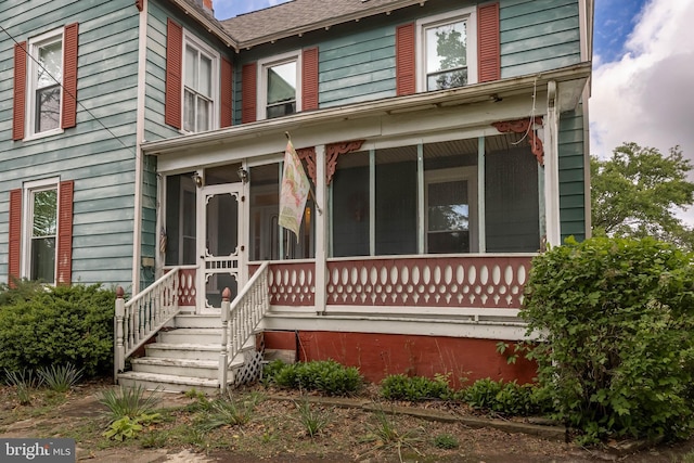 view of front of property featuring a sunroom