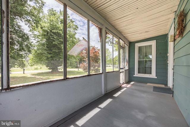 unfurnished sunroom featuring vaulted ceiling