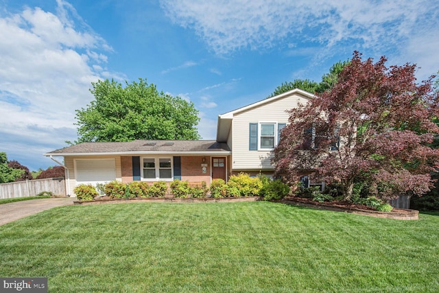 split level home featuring a garage, concrete driveway, and brick siding