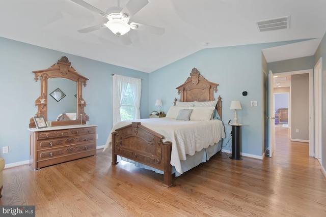 bedroom with vaulted ceiling, light wood-type flooring, baseboards, and a ceiling fan