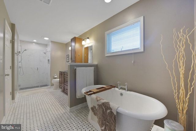 bathroom with vanity, a shower stall, a soaking tub, toilet, and recessed lighting