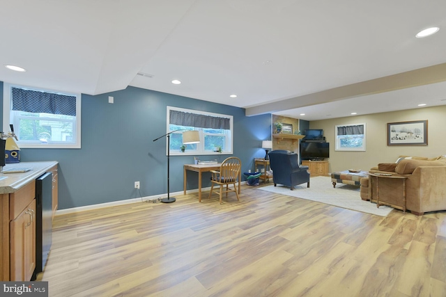 living room featuring light wood-style floors, recessed lighting, and baseboards