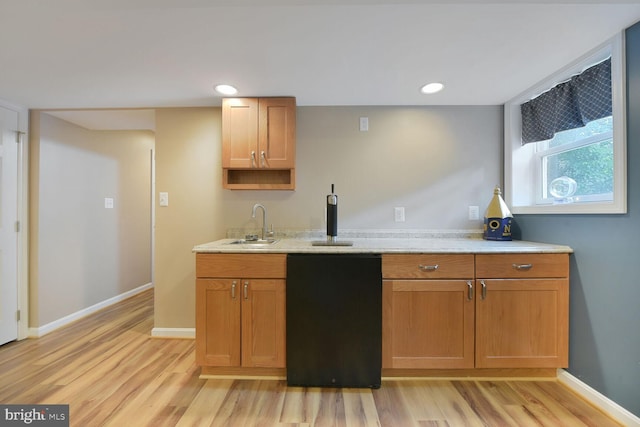 kitchen featuring light wood-style floors, a sink, baseboards, recessed lighting, and black dishwasher