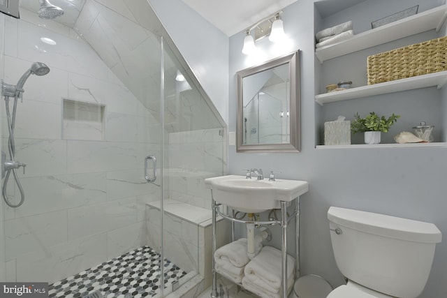 full bath featuring a stall shower and toilet