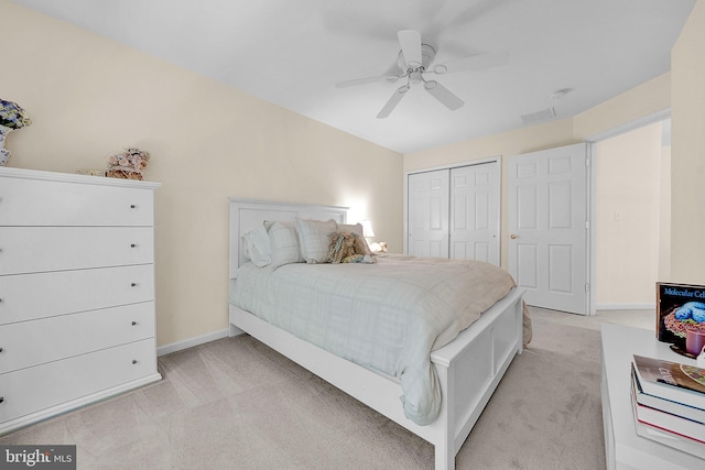 bedroom featuring light colored carpet, a closet, and baseboards