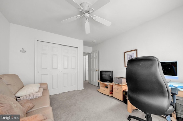 office area featuring a ceiling fan and light carpet