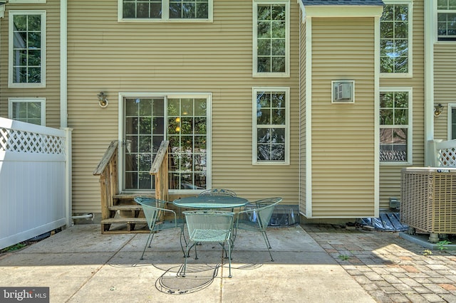 back of property featuring central AC unit, a patio area, entry steps, and fence