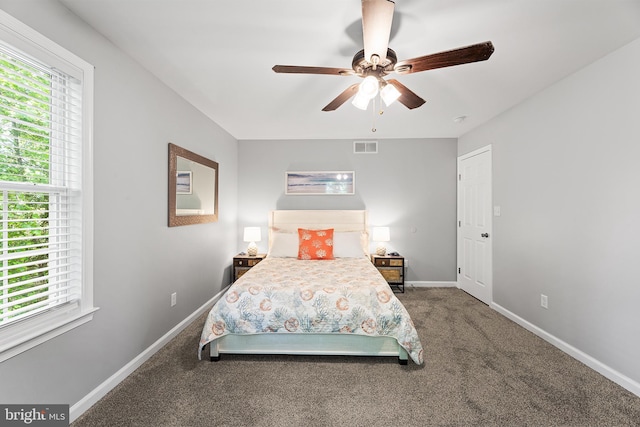 carpeted bedroom featuring baseboards and a ceiling fan