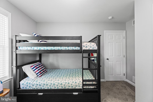 bedroom with carpet flooring and baseboards